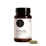 Die Kürbiskern-Produktdose von Medicom in der Vorderansicht und eine Kapsel Kürbiskernpulver im Vordergrund