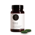 Die Produktdose von Nobilin Antiox® mit zwei grünen Soft-Gel-Kapseln im Vordergrund