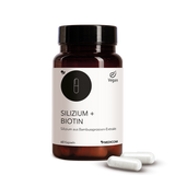 Die Produktdose von Silizium + Biotin in der Vorderansicht und zwei Kapseln vor der Produktdose